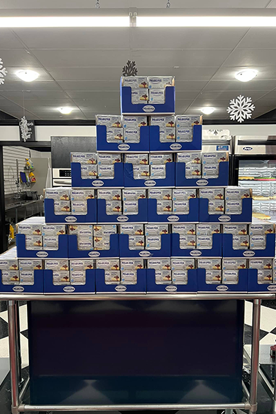 A table topped with lots of boxes in the shape of a pyramid.