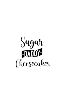 A white apron with the words sugar daddy cheesecakes on it.