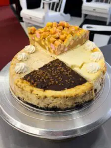A cheesecake with different toppings on top of it.
